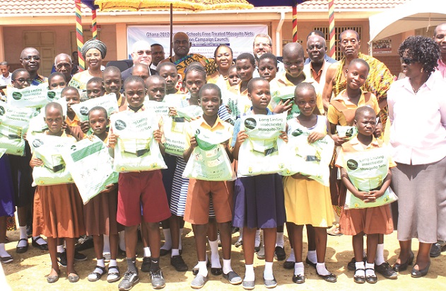 A section of the beneficiaries displaying their nets in a group photograph with some dignitaries A section of the beneficiaries displaying their nets in a group photograph with some dignitaries